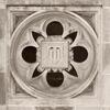 the university seal in stone on the side of a building on main campus