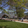 People walk on Temple's Main Campus during the day near the Charles Library.
