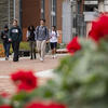 Students walking on Main Campus with red flowers in the foreground